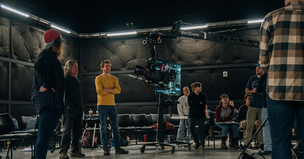 Film school students observing on-set camera work, learning about AI voice synthesis and AI dubbing technology in filmmaking