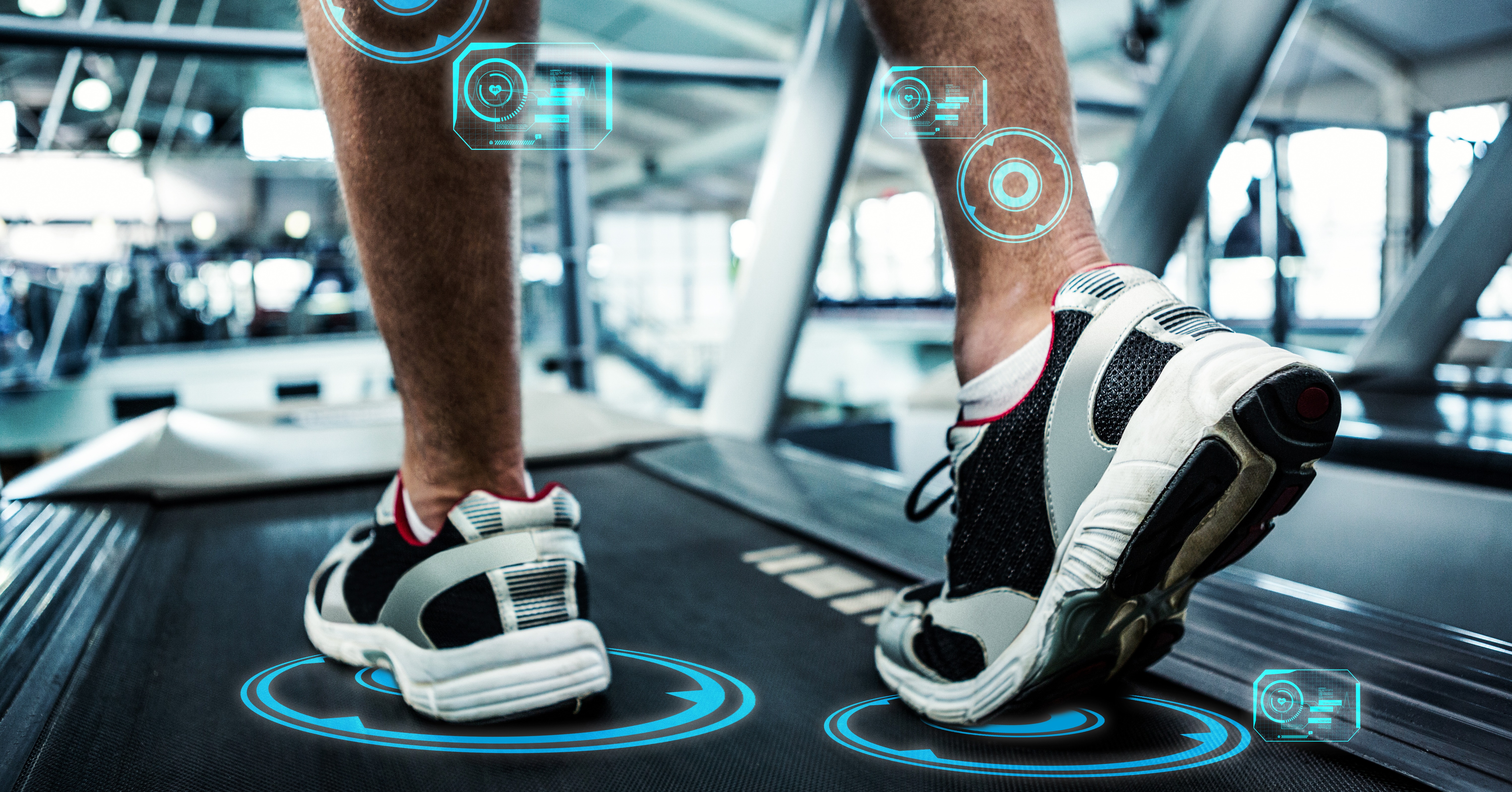 A person running on a treadmill with futuristic digital overlays on their legs, symbolizing advanced technology for online fitness businesses