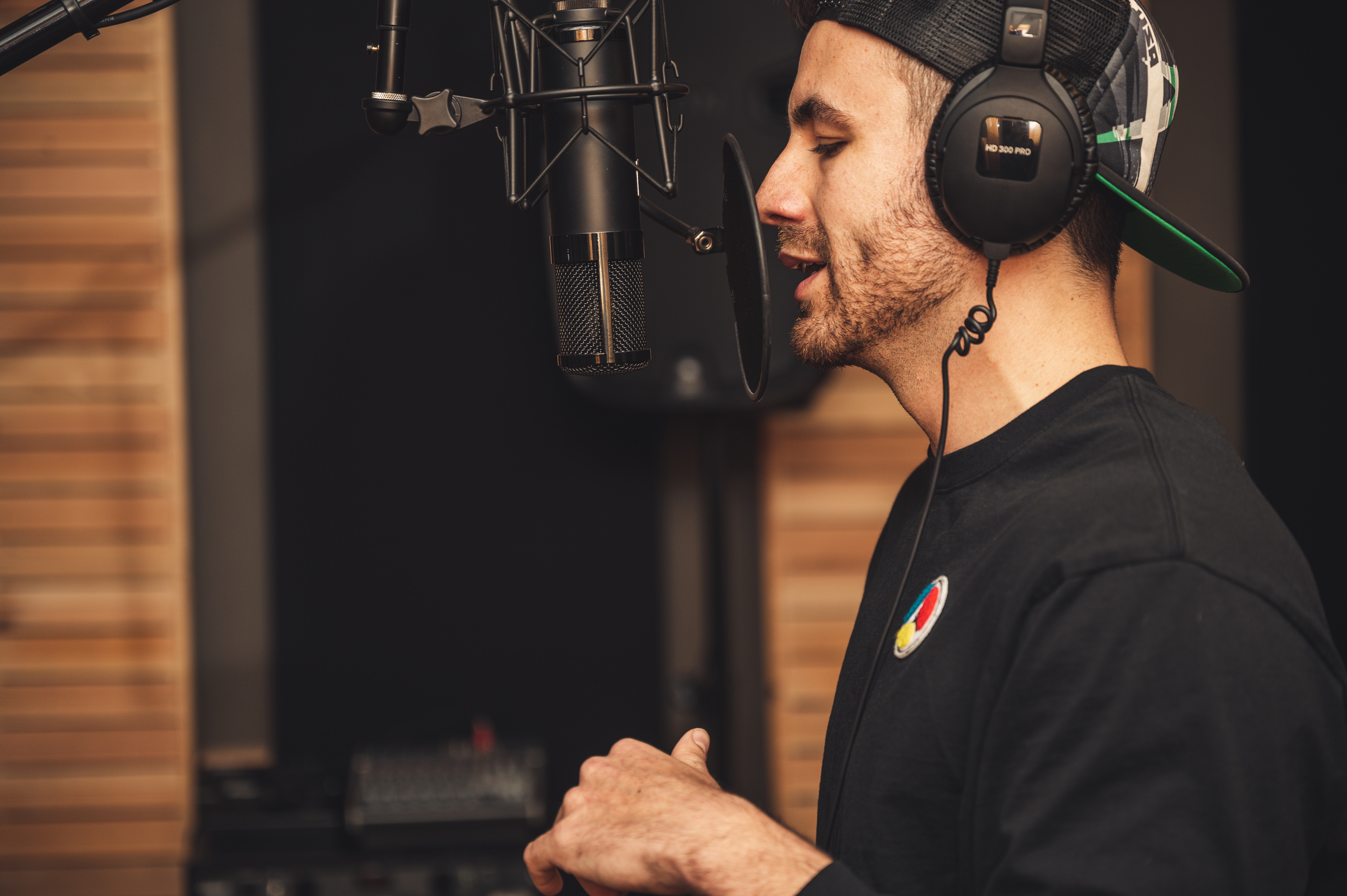 Male voice artist recording in a studio, illustrating the process of creating multi-language content through AI voice cloning technology